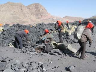 Workers transport coal in carts at China’s Rujigou